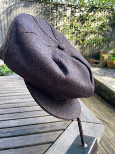 chocolate brown tweed with faint blue and red check baker boy cap on hatstand
